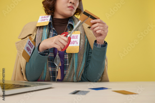 Asian Woman Wearing Layers Of Clothes With Sale Price Labels