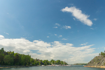 Boats and yachts in the harbour seen from the Vallisaari island on a bright summer day in Southern Finland