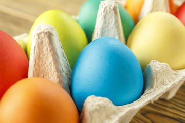 Bright Easter eggs in a special stand. Happy Easter. Close-up, blurred background. The texture of the shell.