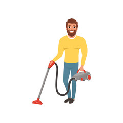 Cartoon character of smiling man with vacuum cleaner. House husband cleaning floor. Young bearded guy in gray yellow sweater and blue jeans. Flat vector design