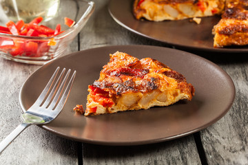 Tortilla de patatas. Spanish omelette with sausage chorizo, potatoes, paprika and egg, accompanied by olive oil