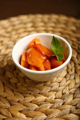 On the plate is a baked pumpkin, near mint. Wicker substrate. Close-up