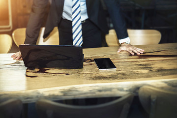 Business and technology concept. Businessman put hands on table with mobile and tablet computer. Picture for add text message. Backdrop for design art work.