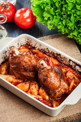 Roasted turkey knuckle with potatoes and vegetable