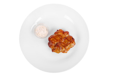 Steak from chicken, pork, grilled meat, barbecue, on a plate isolated white background. Tartar, sour cream, mayonnaise sauce. Juicy fillet roast. For the menu in the restaurant, bar. View from above