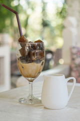 Ice coffee cubes with milk jug.