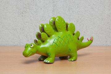 Stegosaurus dinosaur toy on wooden table.