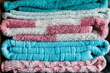ironed and folded colored towels in closet