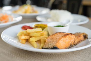 Grilled salmon steak with french fries.