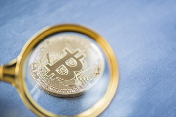 Viewing and the increase in bitcoin through a magnifying glass. electronic money