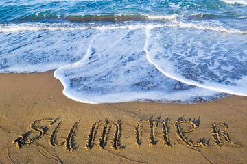 The inscription summer on sand.