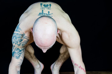 Muscular man performs Yoga and meditation