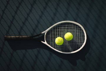 Tennis ball and racket in tennis court