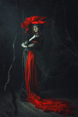 Beautiful model rose hat  is posing in a dark studio 