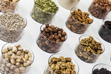 different nuts on the counter of the store. Hazelnuts, sunflower seeds, walnuts, almonds, pumpkin seeds, pistachios and others