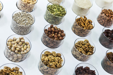 different nuts on the counter of the store. Hazelnuts, sunflower seeds, walnuts, almonds, pumpkin seeds, pistachios and others