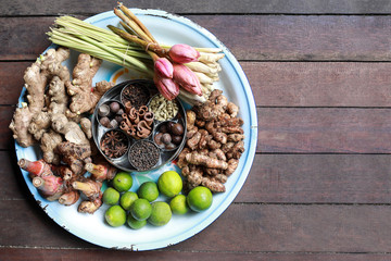 Aromatic spices on a dark background - star anise, fragrant pepper, ginger,  galanga, calamus root, cinnamon, nutmeg close up. Spices texture background.
