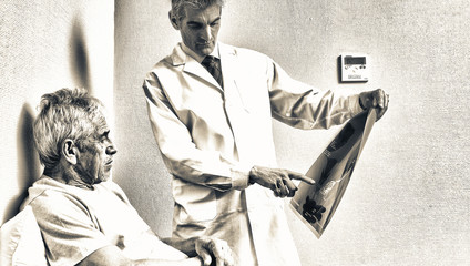 Doctor showing medical scan to elderly man