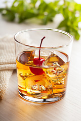 Cold summer cocktail drink with cherry