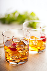 Cold summer cocktail drink with cherry