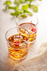Cold summer cocktail drink with cherry
