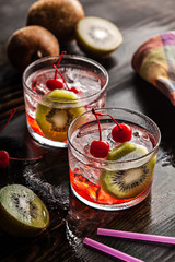Cold summer cocktail drink with cherry and kiwi