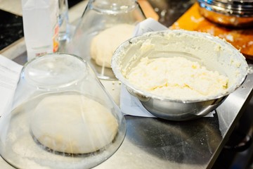 Raw yeast dough under glass bowl