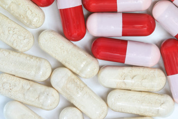 Top view of red and transparent probiotics and antibiotics capsules