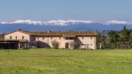 Country and golf resort in the Tuscan countryside against snowy mountains, Pontedera, Pisa, Tuscany, Italy