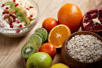 Breakfast still life with oatmeal porridge and fruits, top view, selective focus, shallow depth of field.