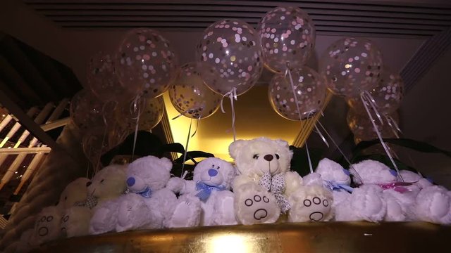 Teddy bears sitting in a row, white teddy bears, helium balloons, cute teddy bear with a butterfly on her neck, soft toy, Interior halls for children's birthday, a gift, a room, indoors, Teddy bear