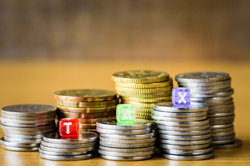 TAX Concept with alphabet block on a gold stacked of coins.