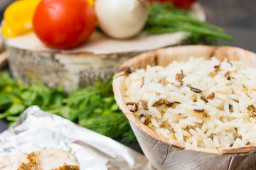 Close up of plate of rice, vegetables, pepper, onions, tomatoes, dill and parsley on background