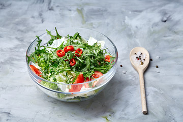 Dietary mixed salad in glass sultana served with wooden spoon on white background, selective focus