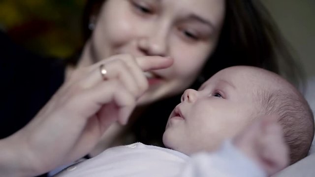 mother of the sweet baby boy big blue eyes gently close up portrait of hand expression were interested in moving chubby cheeks focused