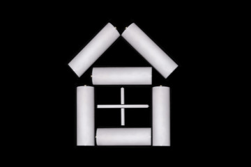 white batteries in the form of a house on a black background, background image