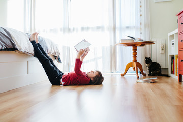boy reading a book at home