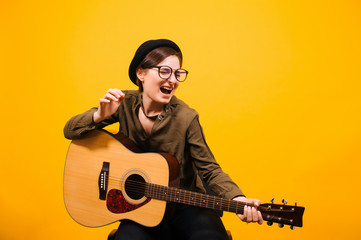Expressive girl playing guitar