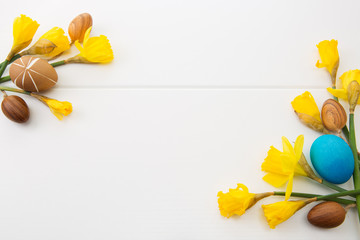 Colorful easter eggs and yellow daffodils.