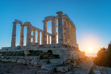 Ruins of the ancient temple of Poseidon at sunset. Greece cape Sounion.
