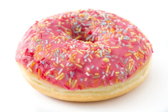 Pink frosted donut with colorful sprinkles isolated on white background