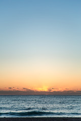 Sunrise or Sunset over the Ocean with Clouds