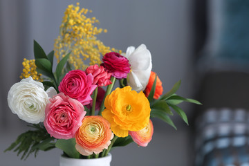 Vase with beautiful ranunculus flowers indoors