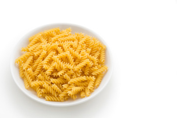 raw pasta in white plate on isolated white background