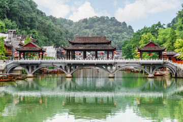 Fototapeta na wymiar Scenic bridge reflected in water of the Tuojiang River, China