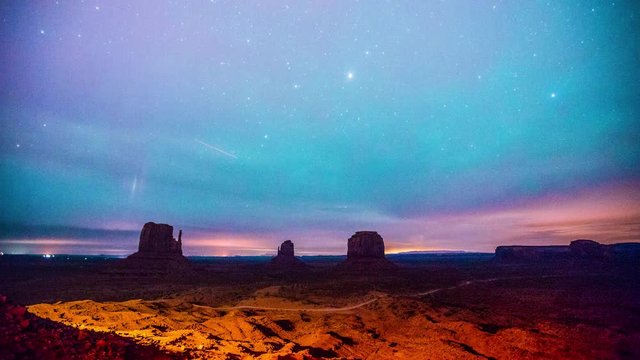Time Lapse - Clouds Moving Over Monument Valley in a Starry Night