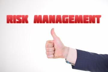 A businessman shows an inscription:RISK MANAGEMENT