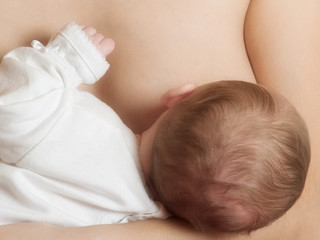 Obraz na płótnie Canvas mother breast feeding her newborn baby