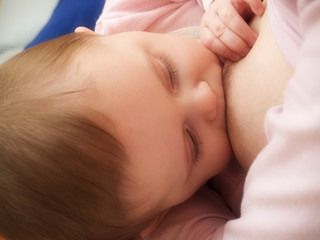 mother breast feeding her newborn baby