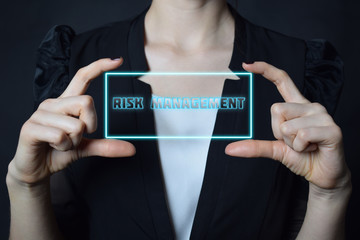 A businessman shows an inscription:RISK MANAGEMENT